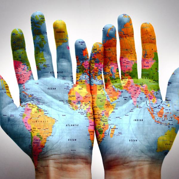 World map covering hands