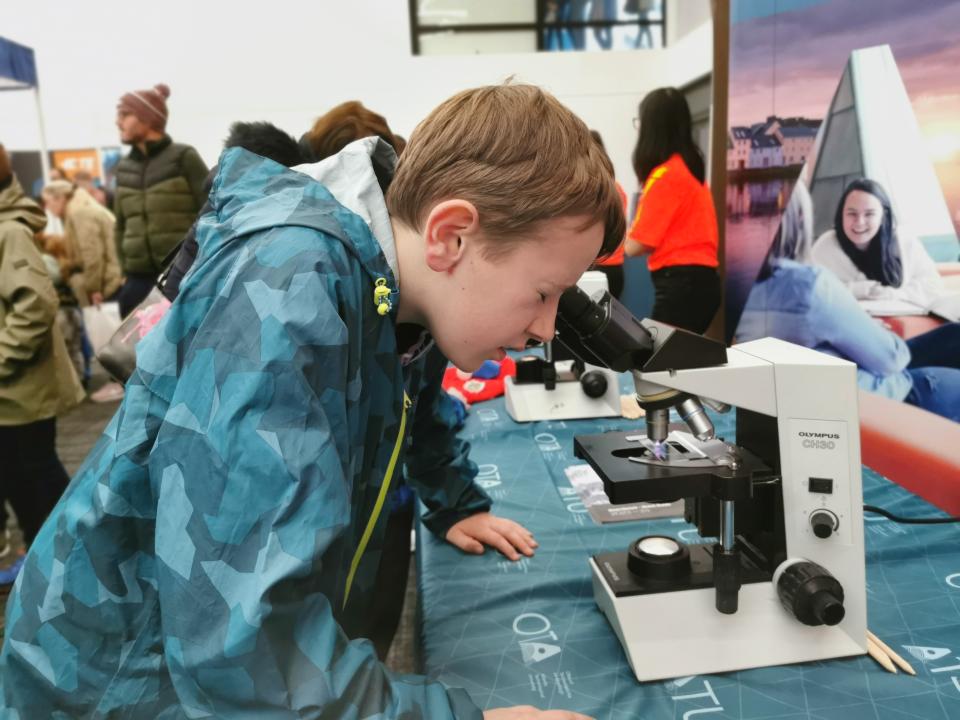Young student with microscope